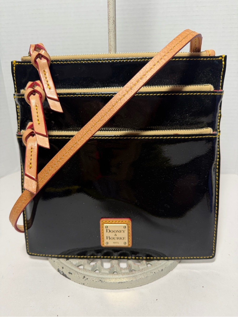Dooney & Bourke patent leather triple zip crossbody bag